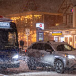 Metro Transit E Line on Hennepin Avenue 1 A Metro Transit E Line bus rolls down Hennepin Avenue in the snow. Passing the Hennepin and 25th Street bus stop.
