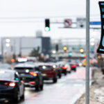 Neighbors Say ICE Out — Lake Street, Minneapolis 3 A handmade banner reading “Neighbors Say ICE Out!” is posted along Lake Street in Minneapolis on December 27, 2025, facing steady winter traffic. The message reflects ongoing local opposition to U.S. Immigration and Customs Enforcement, expressed not through an organized demonstration but as a fixed, neighborhood-level statement embedded in daily urban movement.
