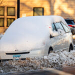 Snow Emergency Ticket 3 A car parked behind snowbanks with a ticket for violation of snow emergency stuck in the window.
