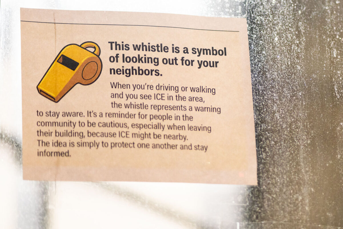 A notice on the doors of the Karmel Mall on Lake Street.This whistle is a symbol of looking out for your neighbors.When you’re driving or walking and you see ICE in the area, the whistle represents a warning to stay aware. It’s a reminder for people in the community to be cautious, especially when leaving their building, because ICE might be nearby. The idea is simply to protect one another and stay informed.