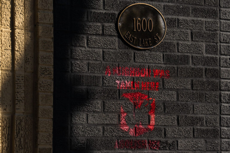 Minneapolis: "A Neighbor Was Taken Here" Stencil Art 1 Stencil art reading "A NEIGHBOR WAS TAKEN HERE" and "ABOLISH ICE" is spray-painted on a brick wall at 1600 East Lake Street in Minneapolis. The message likely refers to Immigration and Customs Enforcement (ICE) operations and arrests within the community. This form of street art serves as a public statement against immigration enforcement policies, particularly in neighborhoods with significant immigrant populations. The date of January 23, 2026, indicates the time the artwork was documented, reflecting ongoing activism and commentary on immigration issues in Minneapolis.