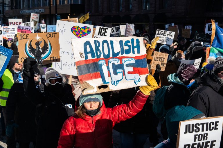 Minneapolis Protestors Demand Abolition of ICE 3 Protesters march in Minneapolis demanding the abolition of ICE, holding signs with slogans like "Abolish ICE" and "Justice for Renee."