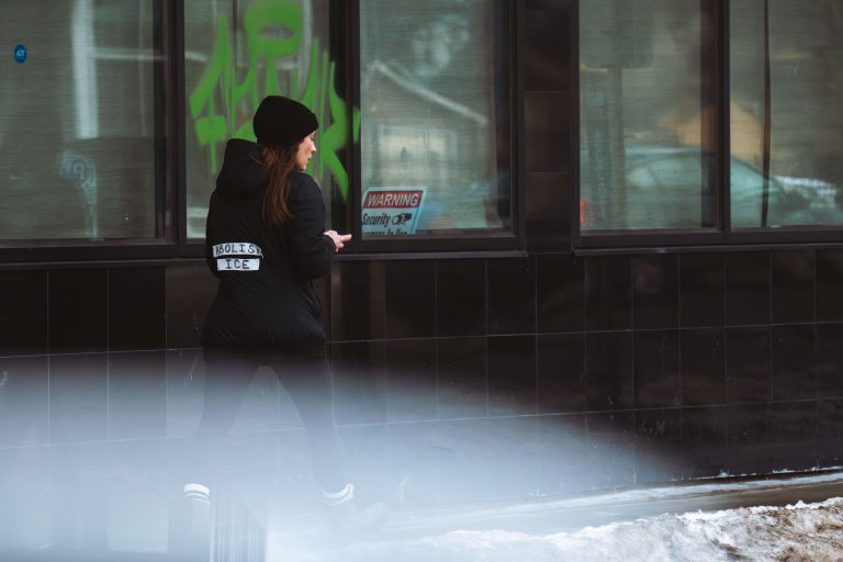 Abolish ICE Rapid Responder in Minneapolis 2 Rapid Responder walks down Lake Street with Abolish ICE stickers