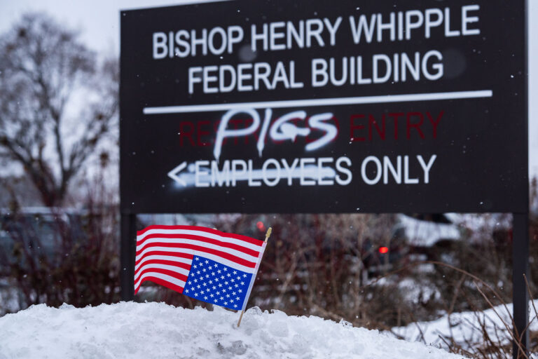 American Flag at Whipple Federal Building 3 An American flag in the snow in front of a graffiti'd sign at the entrance of the Whipple Federal building near Minneapolis on January 16, 2026.