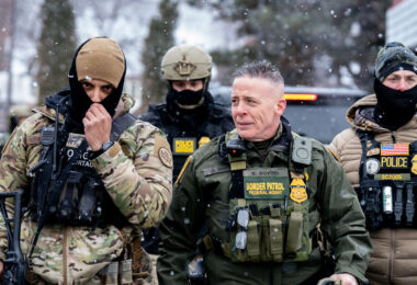 Border Patrol Commander Greg Bovino walks alongside BORTAC officers at a Speedway gas station in Minneapolis on January 22, 2026.