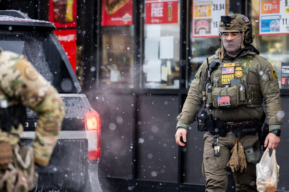 A Border Patrol officer wearing a GoPro on his head goes into a gas station in South Minneapolis on January 21, 2026. This while other agents shoot close up photos of citizens outside the gas station.