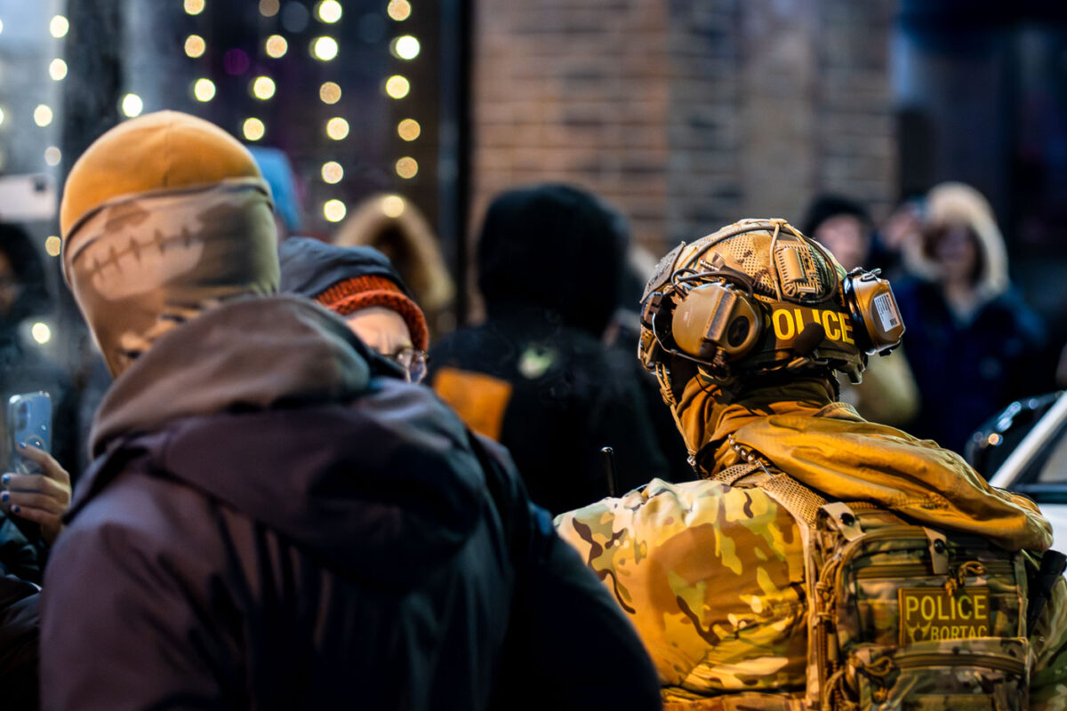 A BORTAC officer interacts with observers on Lake Street in Minneapolis. I've been told 2 agents or contractors connected to ICE were eating at the Indian grill when they felt uncomfortable after being recognized. They then called for backup to be removed from the restaurant.