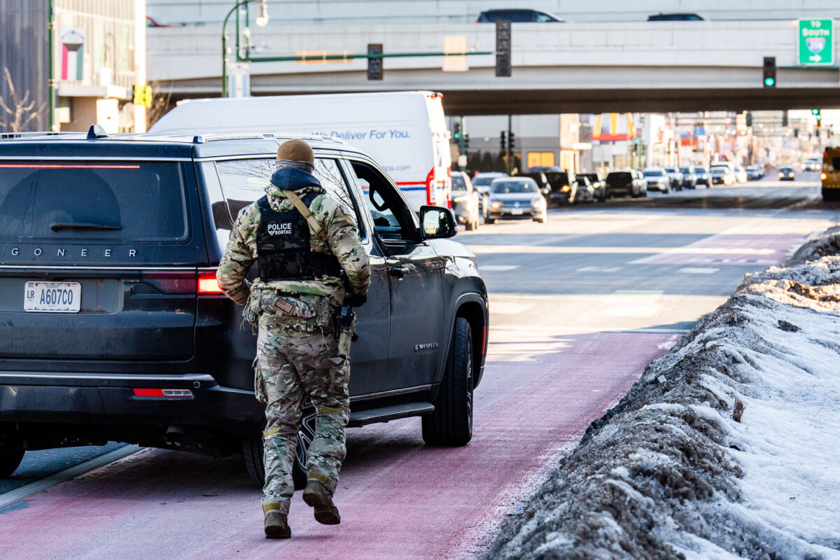 BORTAC officer runs back to a vehicle on Lake Street in Minneapolis on January 14, 2026.