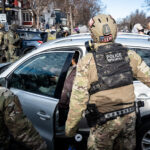 BORTAC Police and a women in her car, Minneapolis 3 Federal agents ram a man's vehicle and demand identification at Park Avenue and 35th Street in Minneapolis on January 12, 2026. The Latino man says he was let go once they realized he was a US citizen. While doing so, a crowd as well as more officers continued to arrive before releasing tear gas and pepper spraying members of the media and their cameras.Park and 35th Street is 2 blocks away from where ICE agents shot and killed Renee Good on January 7, 2026.