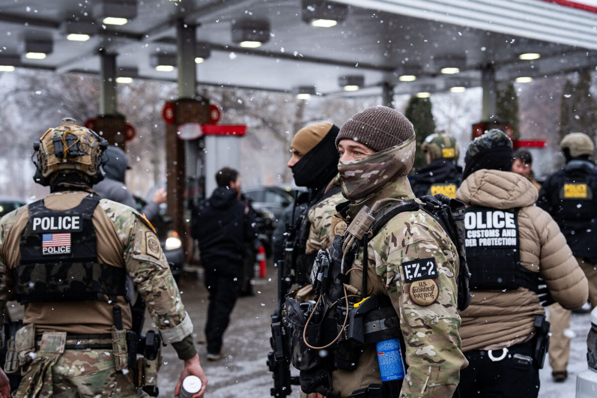 Border Patrol officers part of the tactical BORTAC unit outside a gas station in South Minneapolis on January 21, 2026.