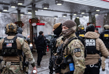 Border Patrol officers part of the tactical BORTAC unit outside a gas station in South Minneapolis on January 21, 2026.