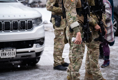 Members of the Border Patrol tactical team, BORTAC, hold cans of tear gas in Minneapolis on January 21, 2026.