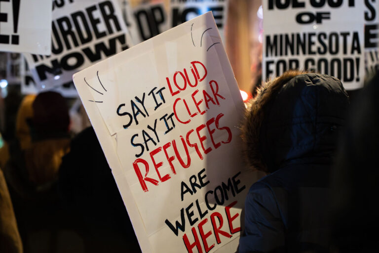 Bye Bovino sign in Downtown Minneapolis 1 Protesters holding up signs at a "Bye Bye Bovino" protest in downtown Minneapolis. Protester holding up a sign "Say It Loud Say It Clear Refugees Are Welcome Here"
