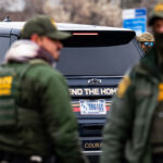 Defend The Homeland Truck in Minneapolis 4 A SUV wrapped with "Defend The Homeland" outside the Whipple Federal Building near Minneapolis.
