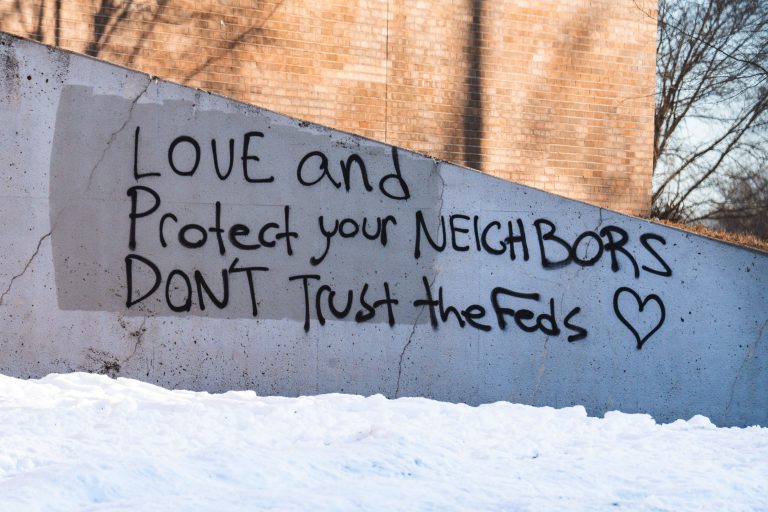 Minneapolis School Graffiti: "Don't Trust the Feds" 2 Graffiti on a concrete wall in Minneapolis reads "LOVE and Protect your NEIGHBORS DON'T Trust the Feds".