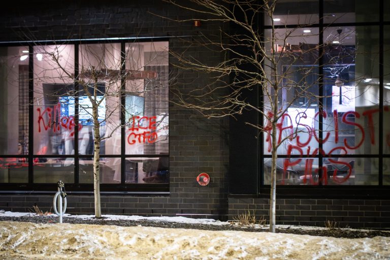 Minneapolis Hotel Vandalized with Anti-ICE Graffiti 1 Red graffiti reading "ICE FASCISTS" and "KILL ICE" covers the windows of the Home2 Suites Hilton in Minneapolis.