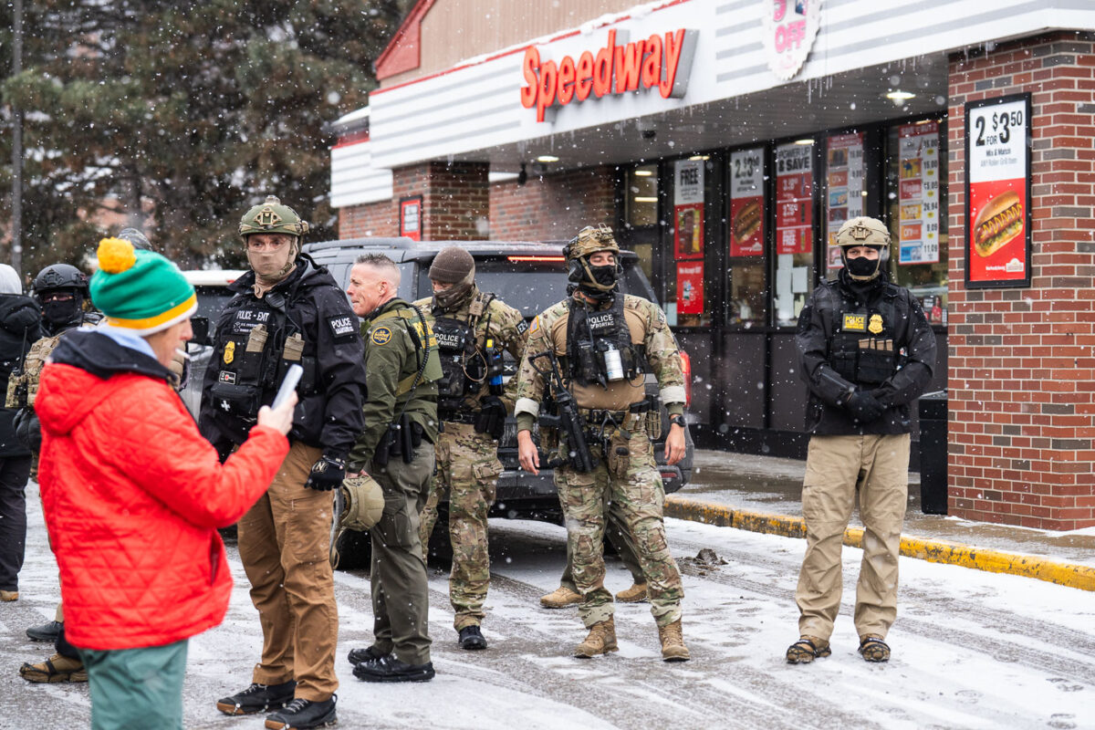 Federal agents outside a Speedway gas station in South Minneapolis as an observer blows a whistle. Seen on January 21, 2026.