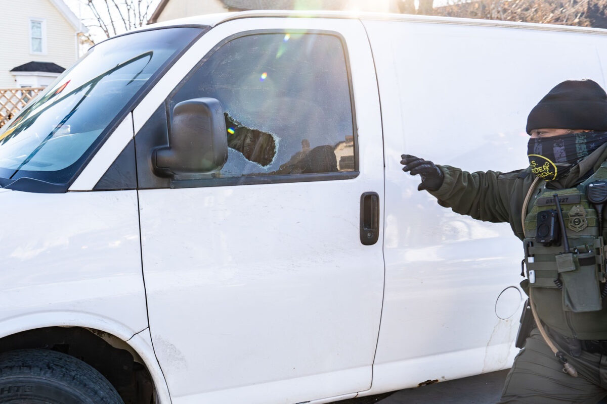 Border Patrol officer tries to get someone to exit their vehicle. Despite efforts, the van was able to drive away.