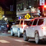 Federal Agents Standing in SUV Doors, Minneapolis 4 An SUV driving down Hennepin Avenue with 2 federal agents standing in the doors in Uptown Minneapolis on January 19, 2026.