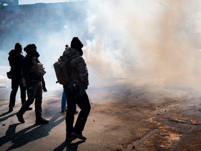 Officers Walk Through Tear Gas Smoke on Nicollet Avenue