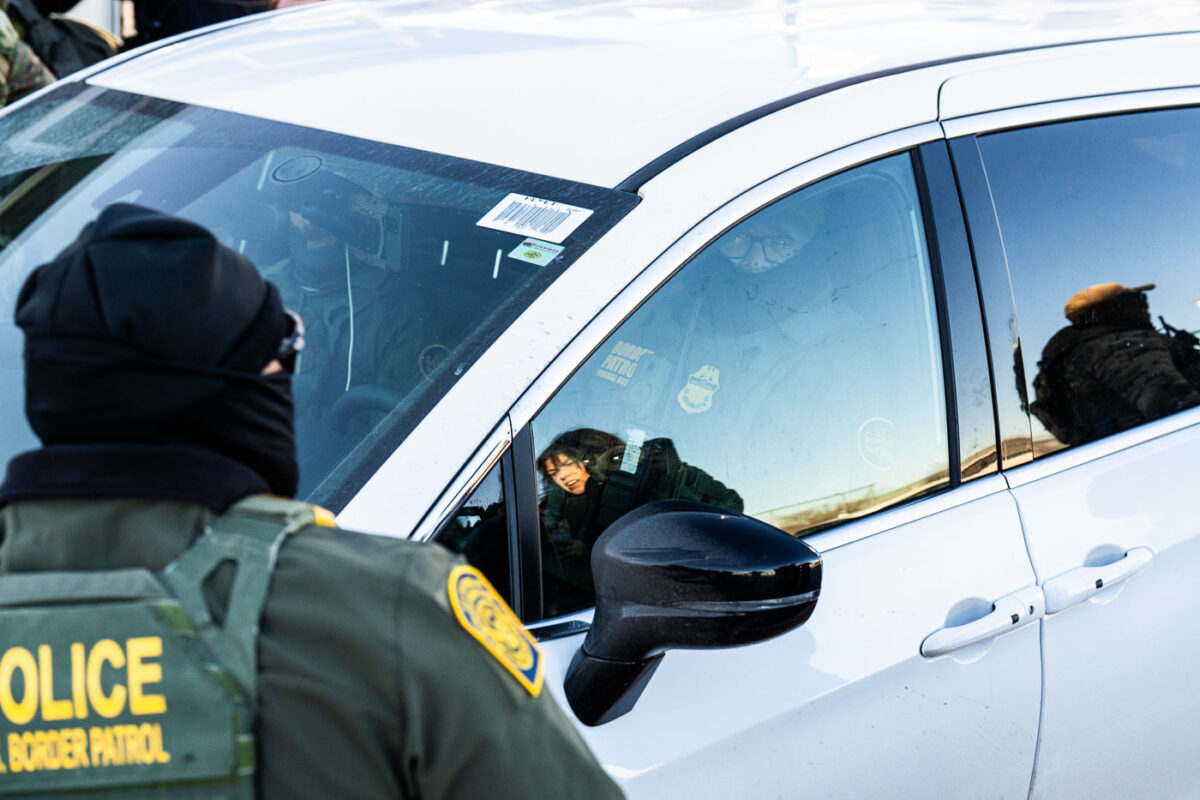 Federal US Border Patrol officers in vehicles on Lake Street in Minneapolis.