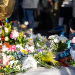 Flowers Placed at Renee Good Memorial, Minneapolis 2 A young girl places flowers at the Renee Good memorial on Portland Ave in South Minneapolis.
