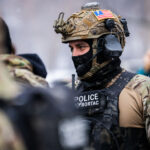 Forward Observations Group Patch, Minneapolis 4 A Border Patrol BORTAC officer wearing a Forward Observations Group patch on his helmet. Seen in Minneapolis on January 21, 2026.