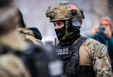 A Border Patrol BORTAC officer wearing a Forward Observations Group patch on his helmet. Seen in Minneapolis on January 21, 2026.