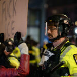 FUCK ICE protester and Minnesota State Patrol 4 Minnesota Conservation Officers, Minnesota State Patrol and Minneapolis Police pushing out hundreds of protesters after declaring an unlawful assembly. Protesters had been holding a noise demo at a downtown hotel they believe ICE agents are staying at.