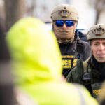 Border Patrol Chief Gregory Bovino in Minneapolis 3 Portland Avenue and 34th Street in South Minneapolis where City of Minneapolis officials have confirmed an ICE agent shot an observer.A neighbor who saw what happened told local MPR news: "She was trying to turn around, and the ICE agent was in front of her car, and he pulled out a gun and put it right in — like, his midriff was on her bumper — and he reached across the hood of the car and shot her in the face like three, four times,”