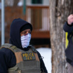 ICE Agent and Protester at Renee Good Scene 2 Portland Avenue and 34th Street in South Minneapolis where City of Minneapolis officials have confirmed an ICE agent shot an observer.A neighbor who saw what happened told local MPR news: "She was trying to turn around, and the ICE agent was in front of her car, and he pulled out a gun and put it right in — like, his midriff was on her bumper — and he reached across the hood of the car and shot her in the face like three, four times,”