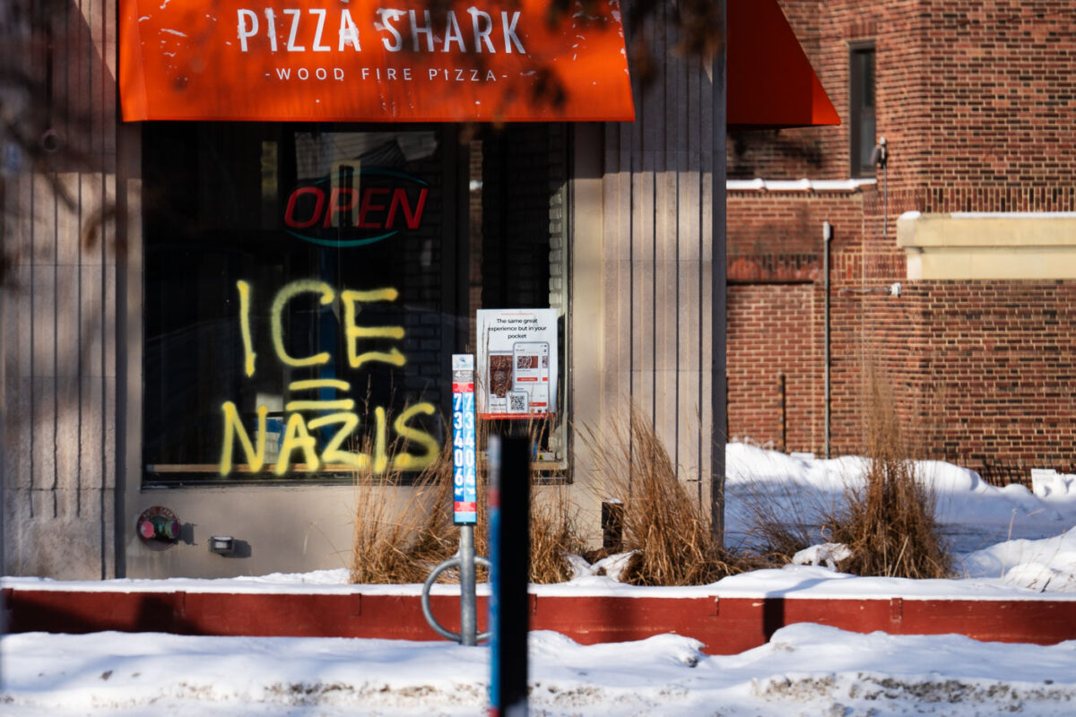 Graffiti in the window of a now closed Pizza Shark pizza shop on Hennepin Avenue in Minneapolis on January 19, 2026.