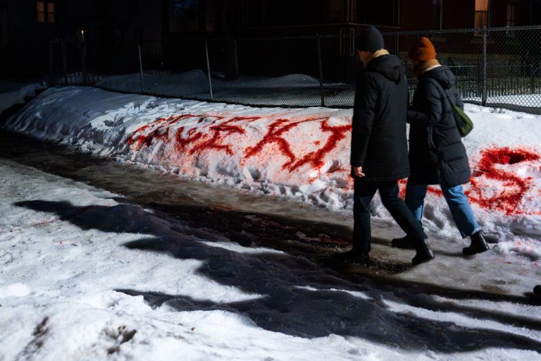 "ICE KILLS" Spray-Painted on a Snowbank on Portland Avenue 4 Red graffiti reading "ICE KILLS" is spray-painted on a snowbank along Portland Avenue in Minneapolis.