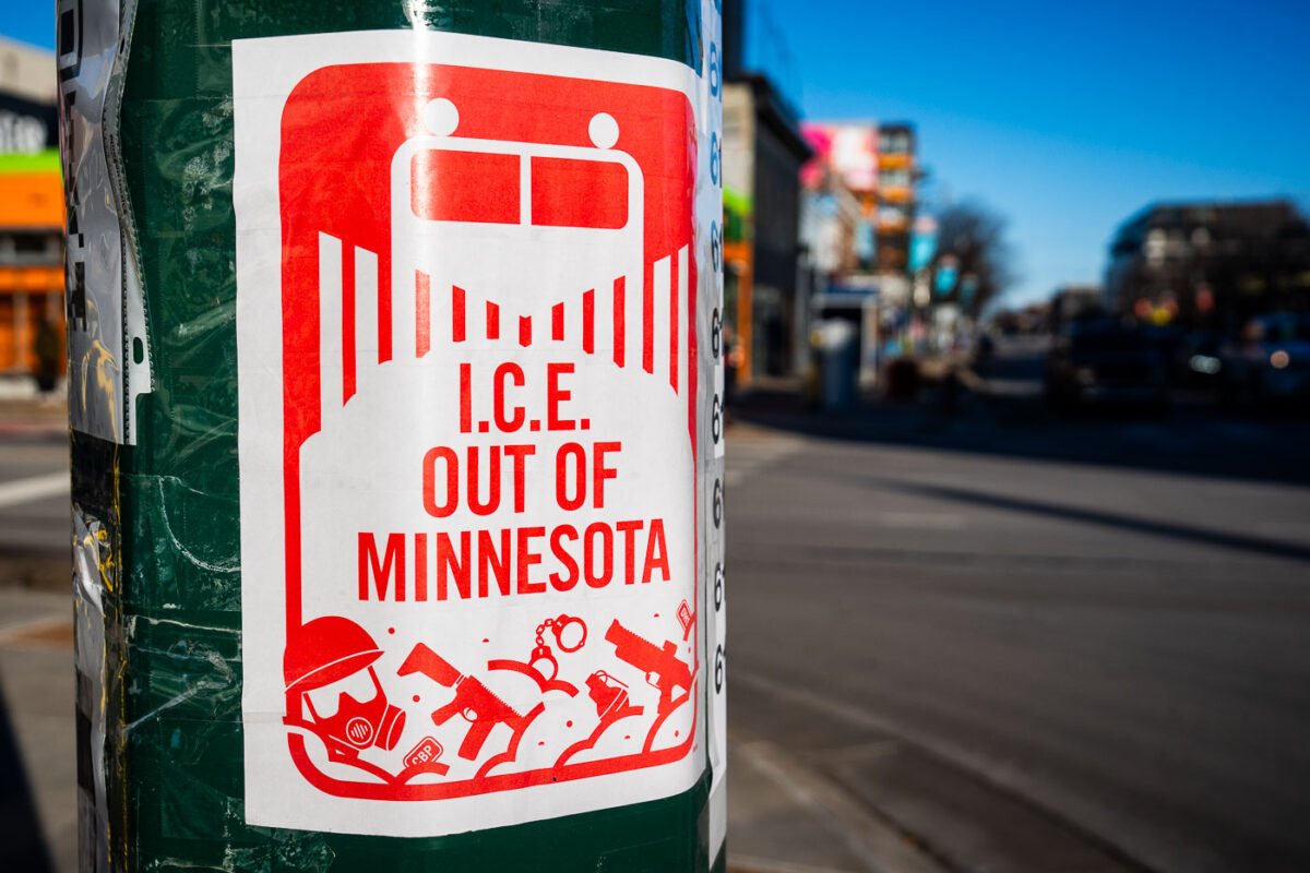 An I.C.E. OUT OF MINNESOTA sign seeing on a street pole on Lyndale Avenue in Minneapolis. The sign resembles the Minneapolis Snow Emergency route sign.