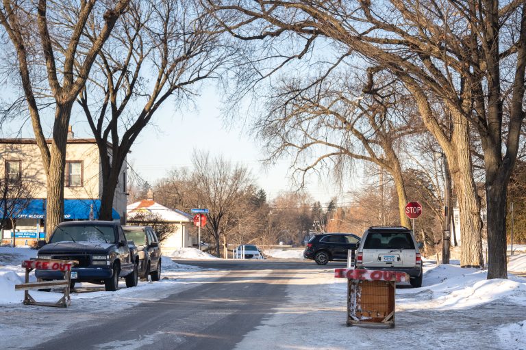South Minneapolis Street Barricades for Traffic Calming 1 Street barricades with "ICE OUT" signage in South Minneapolis, Minnesota, during winter.