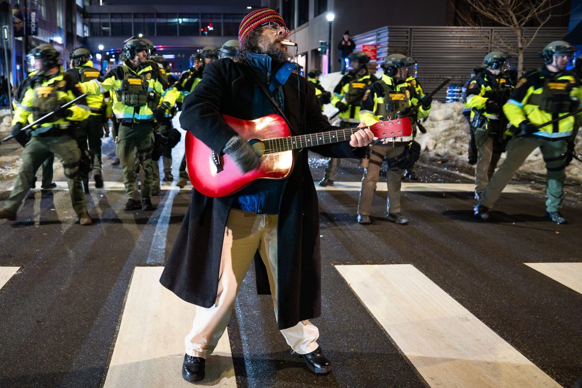 Man on guitar at ICE Noise Demo in Minneapolis