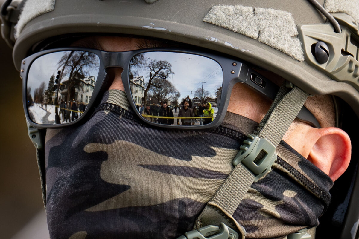 Minneapolis residents reflected in Border Patrol sun glasses