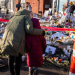 Mom and Daughter at Alex Pretti Memorial 2 A mom and daughter at the Alex Pretti Memorial on January 27, 2026. Pretti was shot and killed by Border Patrol officers on January 24th, 2026.