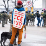 Neighbors Say ICE OUT, Minneapolis 4 A protester with his dog at the Whipple federal building.
