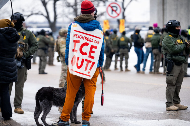 Neighbors Say ICE OUT, Minneapolis 3 A protester with his dog at the Whipple federal building.