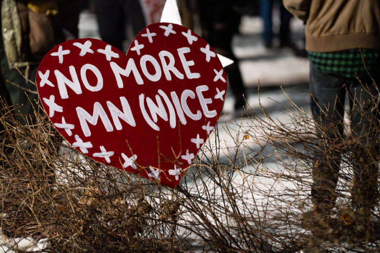 Minneapolis Protest Sign for Renee Good 2 A protest sign reading "No More MN (N)ice" is displayed at a vigil for Renee Good in Minneapolis. Good was killed by an Immigration and Customs Enforcement (ICE) agent earlier on the day the vigil was held. The sign reflects local opposition to ICE operations and policies within Minnesota, particularly in the context of this tragic event. The vigil served as a public gathering to mourn Good's death and protest against ICE actions.