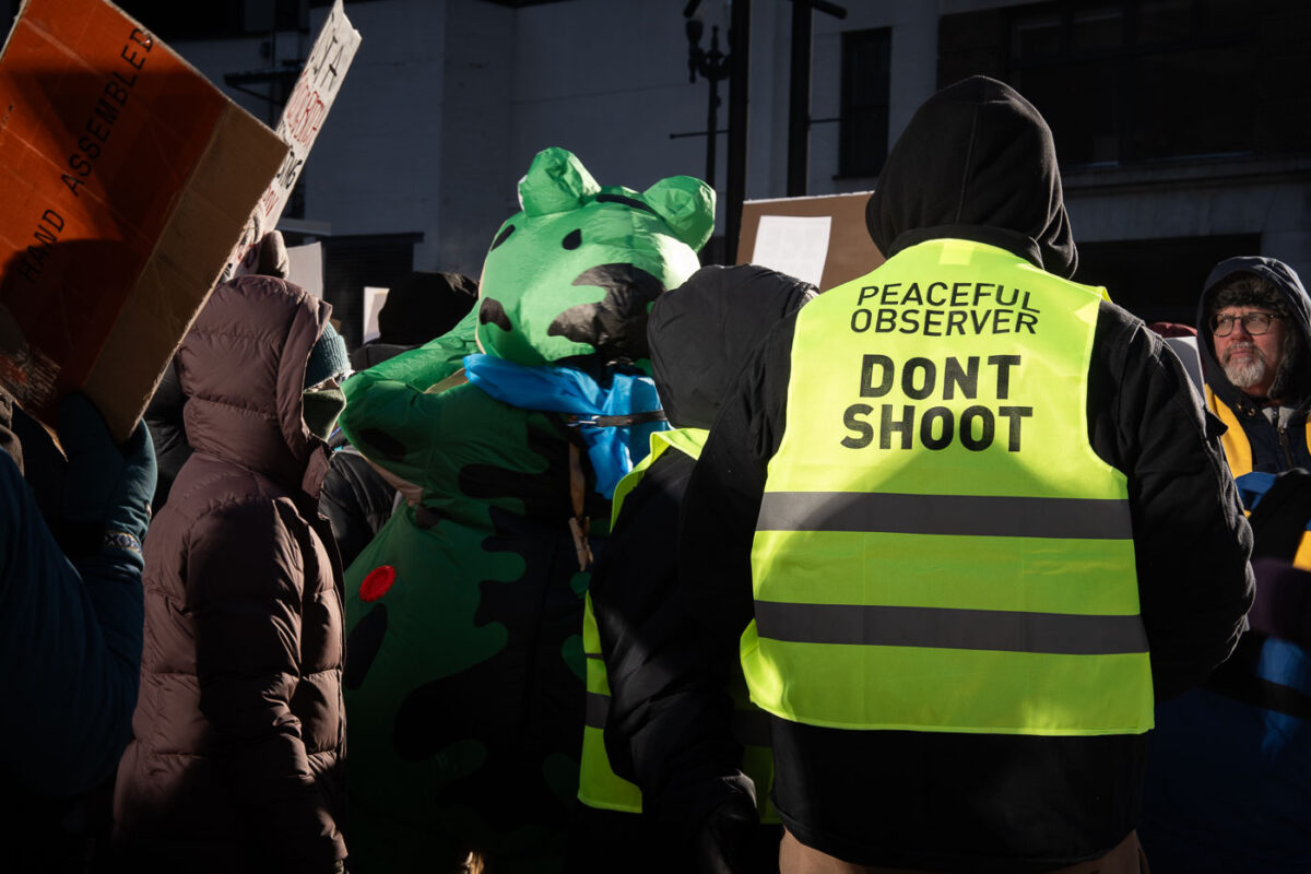 Thousands march through downtown Minneapolis on January 23, 2026. Marching through -30F windchills, they are protesting the actions of federal agents that have been deployed to the city since December.Vest that reads "Peaceful Observer Don't Shoot".