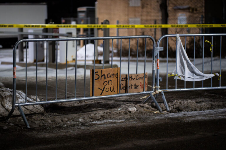 Protest signs at Whipple Building at night 1 Protest signs reading "Shame On You" "Keep the immigrants deport the racists" seen on barricades at the Whipple Building near Minneapolis. The Whipple building is being used as a ICE detention center and "homebase" for thousands of federal agents in Minneapolis.