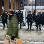 Springhill Suites Noise Demo, Maple Grove 2 Anti-ICE protesters and police officers in riot gear outside a Noise Demonstration at Springhill Suites on January 26, 2026 in Maple Grove, Minnesota.