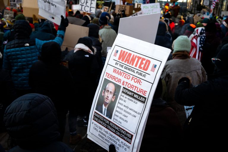 Minneapolis Protest Against Federal Agents, Stephen Miller Wanted 4 Protesters in Minneapolis hold a "Wanted" poster for Stephen Miller during a march against federal agents.