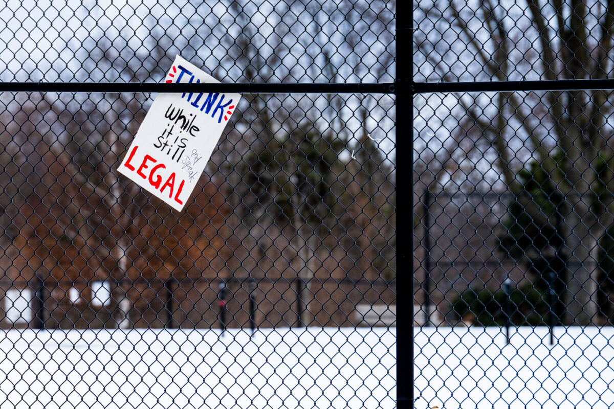 A sign stuck to a fence in Minneapolis on January 13, 2026. It reads "Think while it is still legal".