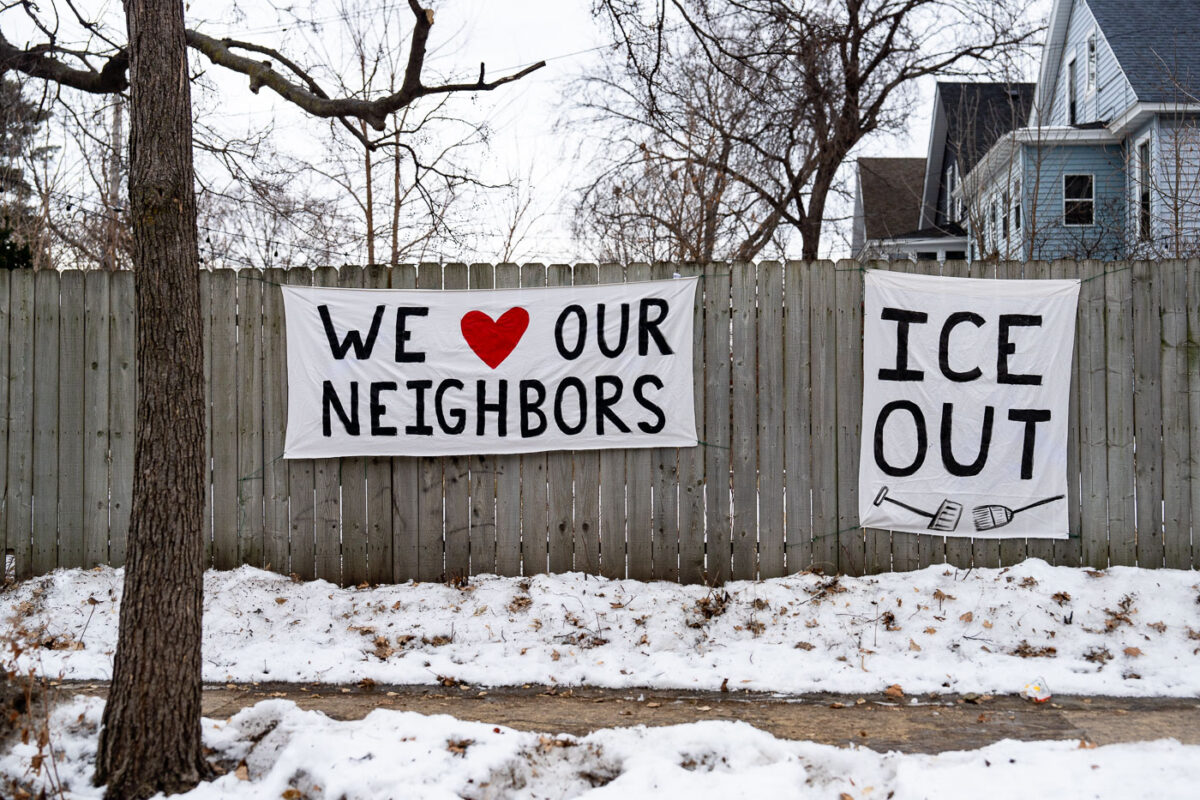 Large banners seen on a fence in South Minneapolis that reads "We Love Our Neighbors" "ICE OUT". Seen on January 15, 2026.