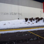 "We'll do it again, ICE OUT NOW!" on the side of the Target across the street from the Minneapolis police station that was burned in 2020.