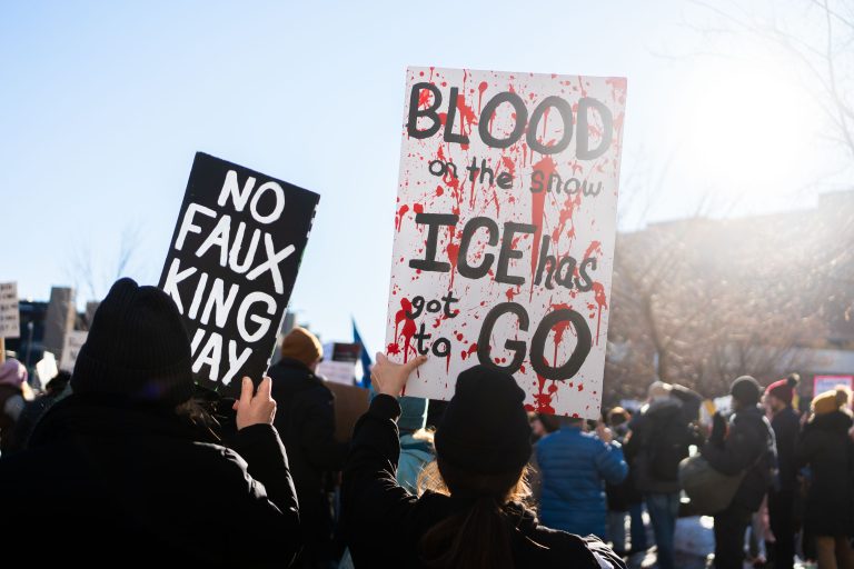 Minneapolis Protest: "Blood on the Snow ICE Has Got to Go" Sign 1 Protesters in downtown Minneapolis hold signs against ICE, including "Blood on the Snow ICE Has Got to Go."