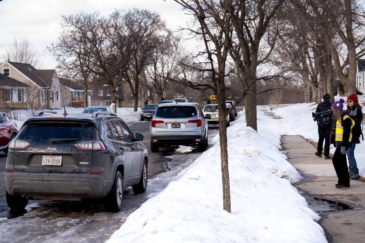 Observers on a street in St. Louis Park, Minnesota where an ICE agent is parked in his vehicle.